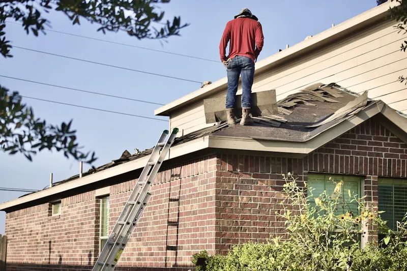 Professional roofer working on a residential roof in Lands End